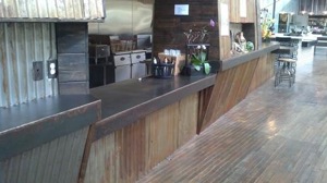imagine a parts counter from plated steel and corrugated tin.  barn wood floors are pretty “tight” too.  