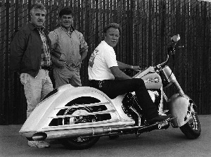 Dron with his landmark Heritage Royale show bike in “the white.”  The red Heritage Softtail body was executed by Oakland coachbuilder Steve Moal  (left) and designed by Don Varner (center). The motorcycle was winner of the prestigious Slonaker Award for Technical Excellence and Best Paint at  the 1992 Grand National Oakland Roadster Show, of which Dron is Hall of  Fame member.